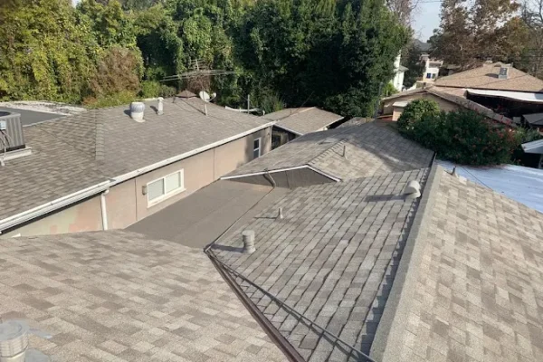 Shingle roofs of a hillside property after replacement