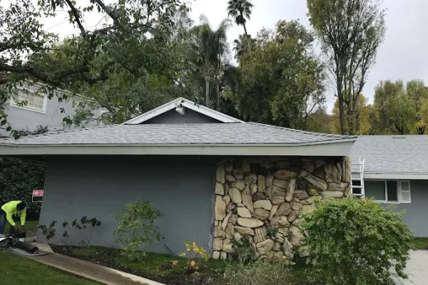 New asphalt shingle roof on a single-story home with stone facade