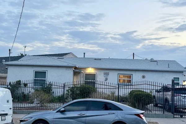 Single-story home with a newly installed shingle roof at dusk