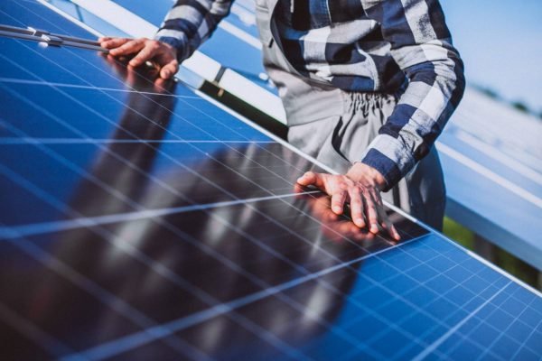Installer positioning a solar panel during installation